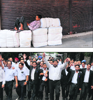 A man rests outside closed shops; (below) lawyers protest against terror strikes in Jammu on Friday.