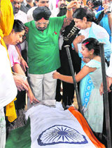 Lt Col Bikramjeet Singhs mother Luvpreet Kaur (left), father Maj (retd) Paramjeet Singh (centre), wife Navneet Kaur and daughter Ramneet pay their last respects at his cremation in Chandigarh on Friday. 