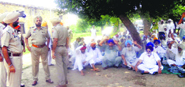 Farmers protest the death of a Mansa farmer outside Civil Hospital in Nabha on Friday.