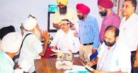 Doctors examine patients during the cancer screening camp at Guru Nanak Dev Hospital in Amritsar on Saturday.
