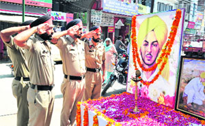 Policemen salute Shaheed Bhagat Singh on his birth anniversary in Bathinda on Saturday.