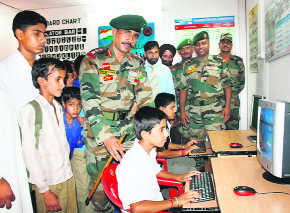 Schoolchildren getting introduced to computer technology at Jhallas village in Poonch.