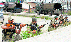 CRPF jawans take position after militants opened fire on an Army deployment at Sanat Nagar on the outskirts of Srinagar on Saturday