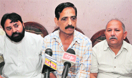 Members of the All J&K Transport Welfare Association address a press conference in Jammu on Saturday.