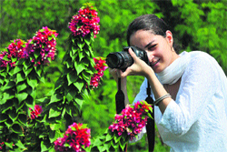 A student clicks pictures during the photography competition at the Bagh-e-Bahu garden in Jammu on Saturday. 