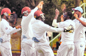 Nikita Miller (second from right) gets his teammates appreciation on the final day of the unofficial Test on Saturday. 