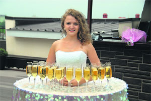 A girl serving Champagne to wedding guests