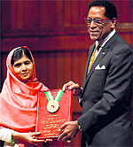 Malala Yousafzai (L) being presented the Peter J Gomes Humanitarian Award at Harvard University in Cambridge on Friday