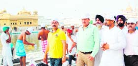 Punjab Local Bodies Minister Anil Joshi (second from right) with supporters pays obeisance at the Golden Temple in Amritsar on Sunday.