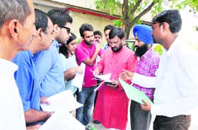 Students and employees submit memorandums to a Senate member before the House meeting at Panjab University in Chandigarh on Sunday