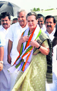 UPA chairperson Sonia Gandhi arrives at the Thiruvananthapuram airport on Sunday. Kerala Chief Minister Oommen Chandy (2L) is also seen.