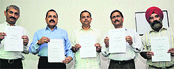 Members of the J&K Civil Society display the interim report on Kishtwar violence, in Jammu on Sunday