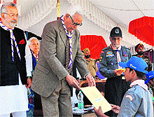 Governor NN Vohra hands over a certificate to a participant at the concluding function of the National Integration Camp in Baramulla on Sunday