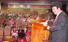 The minister addresses a gathering.