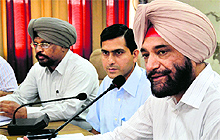 AS Pannu (right), Commissioner, Patiala Division, addresses officials and representatives from political parties at the Bachat Bhawan in Ludhiana on Sunday