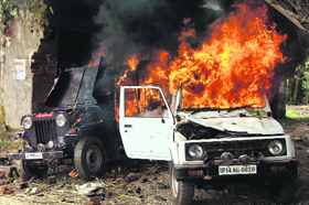 A police jeep on fire after villagers clashed with the police at Khera village of Meerut on Sunday.