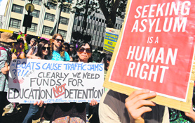 Protesters carry placards at a Welcome Refugees rally in Sydney on Sunday.