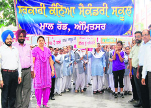 Staff and students of Government Girls Senior Secondary School at a voter awareness rally in Amritsar on Monday. 