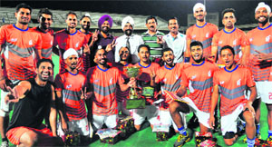 The team members of Punjab and Sindh Bank strike a pose after winning the 43rd SN Vohra's All-India Gurmit Memorial Hockey Tournament at Sector 42 in Chandigarh on Monday.