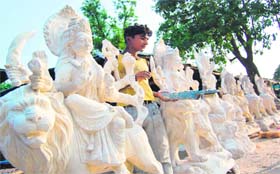 An artiste makes sculptures and idols of deities ahead of the festival season in Haridwar on Monday.