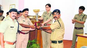 Indian Reserve Police Commandant Neeru Garg and 40-PAC Commandant Arun Mohan Joshi hand out a trophy to a winning team in the Inter-District State Police Championship in Haridwar.