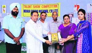 Preet Pal Singh, sarpanch of Dhanora village (second from left), gives prize to a winner while principal Dr Prem Kumari Gupta looks on during the concluding day of two-day talent-hunt contest. 