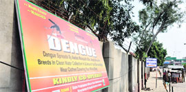 A signboard displaying precautions to be taken against dengue installed by the Directorate of Health Services at the railway station in Jammu on Monday.