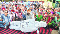 Members of the BEd Teachers Front stage a dharna outside the DCs office in Ludhiana on Monday. 
