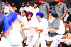 Chief Minister Parkash Singh Badal, flanked by former Speaker NS Kahlon and his son Ravi Kiran Kahlon, at the Sangat Darshan in Batala on Monday. 