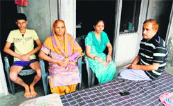 Atul's (inset) father Hem Raj and other family members at their house in Amritsar on Monday. 