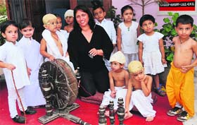 Tiny-Tots of Daddys Teddy playway school spin a wheel (charkha) to mark the birth anniversary of Mahatma Gandhi in Bathinda on Tuesday.