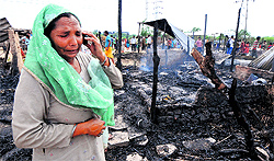 A woman talks to her kin informing them about the fire that broke out in Maloya Colony on Tuesday