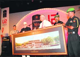 Lt Gen Manvendra Singh, Commandant of the Indian Military Academy (IMA), presents a memento to Uttarakhand Governor Aziz Qureshi on the 81st Raising Day of the academy in Dehradun on Tuesday