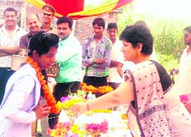 District Judge Kumkum Rani felicitates a meritorious student at a legal aid workshop held in Laldhang, Haridwar, on Tuesday