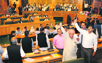 BJP legislators raise slogans against the government as they stage a walkout from the Assembly in Srinagar