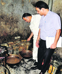 Health officials check a sweets shop at Khajur Chowk in New Ashok Nagar in Ludhiana.