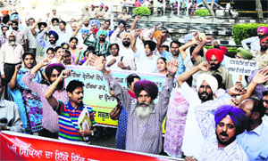 Government schoolteachers hold a protest outside the Mini-Secretariat in Ludhiana on Tuesday.