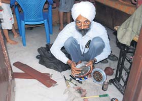 A mechanic repairs a fan