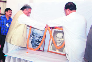 Uttarakhand Chief Minister Vijay Bahuguna and State Congress Chief Yashpal Arya garland the photographs of Mahatama Gandhi and Lal Bahadur Shastri on their birth anniversaries in Dehradun on Wednesday