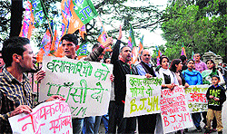 Activists of the Bhartiya Janata Yuva Morcha raise slogans in protest against rape incidents in Shimla on Wednesday