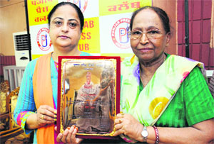 Hindi writer Dr Kirti Kesar (right) shows an award received by her from the UP Hindi Sansthan in Jalandhar. 