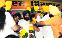 Revenue and Public Relations Minister Bikram Singh Majithia being garlanded by Akali leaders during the lalkar rally in Ludhiana.