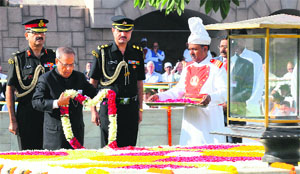 President Pranab Mukherjee pays homage to Mahatma Gandhi at Rajghat in New Delhi on Wednesday.