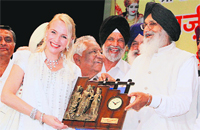Chief Minister Parkash Singh Badal presents a memento to Danish singer Anita Liakre during a function in Jalandhar on Wednesday. Photo: Sarabjit Singh