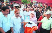 Naval officials hand over Seaman Atul Sharmas uniform and other belongings to his mother in Amritsar on Wednesday. Photo: Sameer Sehgal