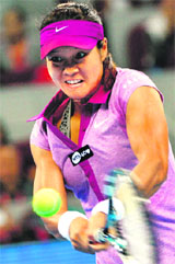 Li Na hits a return against Sabine Lisicki during their match at the China Open in Beijing on Wednesday