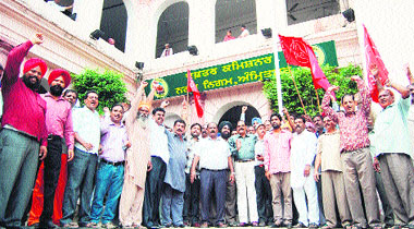 MC employees stage a protest outside the Municipal Commissioners office against the non-payment of their salaries for the past two months, in Amritsar on Thursday. 