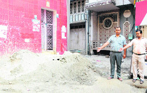 Residents of the Tunda Talab area show the site where a tubewell was proposed to be installed, obstructing the way to their houses. 
