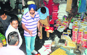 A Health Department team collects samples during a raid at a sweets manufacturing unit at Batala Road in Amritsar. 