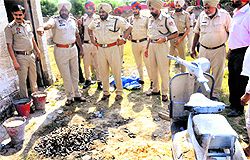 Senior Superintendent of Police Ravcharan Brar along with other police officials at the explosion site on the outskirts of Bathinda city on Thursday